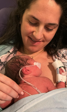 Photo of a mother giving her baby kangaroo care (holding skin to skin)